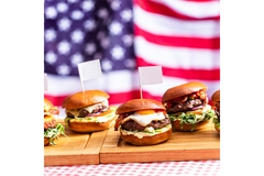 Image Beef burgers in front of American flag.